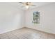 This cozy bedroom is bright with tile flooring and a ceiling fan at 896 Satin Leaf Cir, Ocoee, FL 34761