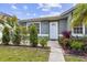 Close up view of the front door surrounded by garden landscaping at 896 Satin Leaf Cir, Ocoee, FL 34761
