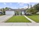 Lovely single-story home with a green lawn, walkway, and beautiful garden, adding to its curb appeal at 896 Satin Leaf Cir, Ocoee, FL 34761