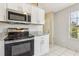 Modern kitchen features stainless steel appliances, white cabinets, and granite countertops at 896 Satin Leaf Cir, Ocoee, FL 34761