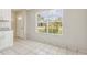 Bright kitchen area featuring white cabinets, granite countertops and natural light from the large window at 896 Satin Leaf Cir, Ocoee, FL 34761