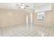 Open-concept living room with tiled flooring and serving hatch view of the kitchen area at 896 Satin Leaf Cir, Ocoee, FL 34761