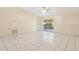 Spacious living room with sliding door access to an enclosed lanai, and tile flooring at 896 Satin Leaf Cir, Ocoee, FL 34761