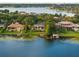 Expansive aerial view of a luxury waterfront community, showcasing beautiful homes and scenic lake at 9724 Chestnut Ridge Dr, Windermere, FL 34786