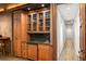 Entertainment bar with a granite countertop, custom cabinets, and glassware storage at 9724 Chestnut Ridge Dr, Windermere, FL 34786