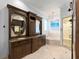 Main bathroom with double vanity, soaking tub, and stand up shower at 9724 Chestnut Ridge Dr, Windermere, FL 34786