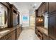 Main bathroom featuring double vanity, soaking tub, and vanity with lights at 9724 Chestnut Ridge Dr, Windermere, FL 34786