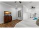 Bedroom featuring an ocean view television, hardwood floors, and shutters at 9724 Chestnut Ridge Dr, Windermere, FL 34786