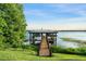 Private boat dock on a tranquil lake setting with lush landscaping and grassy yard at 9724 Chestnut Ridge Dr, Windermere, FL 34786