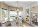 Cozy breakfast nook with water views, built-in bench seating, and access to an outdoor dining area through glass doors at 9724 Chestnut Ridge Dr, Windermere, FL 34786