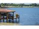 Well-maintained boat dock and lift on a serene lake, offering convenient access to water activities at 9724 Chestnut Ridge Dr, Windermere, FL 34786