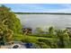 Picturesque waterfront home with a private dock, lush landscaping, and outdoor living space at 9724 Chestnut Ridge Dr, Windermere, FL 34786