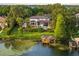 Stunning lakefront property featuring a private dock, lush landscaping, and beautiful home exterior at 9724 Chestnut Ridge Dr, Windermere, FL 34786