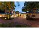 Elegant home exterior with a circular driveway, professional landscaping, and inviting entrance at 9724 Chestnut Ridge Dr, Windermere, FL 34786