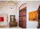 Elegant foyer with a chandelier, wooden door, and stylish decor at 9724 Chestnut Ridge Dr, Windermere, FL 34786