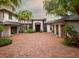 Stunning home featuring a brick driveway, lush landscaping, and a grand entrance at 9724 Chestnut Ridge Dr, Windermere, FL 34786