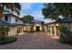 Elegant home with brick driveway, three garages, palms, and well maintained landscaping at 9724 Chestnut Ridge Dr, Windermere, FL 34786