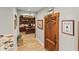 Hallway view of the home office, decorated wall art, and wine cellar door at 9724 Chestnut Ridge Dr, Windermere, FL 34786