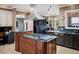 Modern kitchen with stainless steel appliances and a granite island at 9724 Chestnut Ridge Dr, Windermere, FL 34786