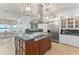 Open gourmet kitchen featuring stainless steel appliances, granite countertops, and island at 9724 Chestnut Ridge Dr, Windermere, FL 34786