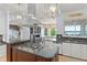 Open gourmet kitchen with granite countertops, stainless appliances, island and lake view at 9724 Chestnut Ridge Dr, Windermere, FL 34786