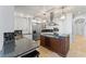 Well-appointed kitchen featuring granite countertops, custom cabinets, a center island, and stainless steel appliances at 9724 Chestnut Ridge Dr, Windermere, FL 34786