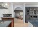Open-concept kitchen seamlessly connects to the living area with an archway, showcasing tile flooring and custom cabinetry at 9724 Chestnut Ridge Dr, Windermere, FL 34786