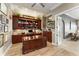 Spacious home office with custom wood built-ins, large desk, ceiling fan, and natural light at 9724 Chestnut Ridge Dr, Windermere, FL 34786