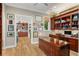 Elegant home office with custom wood paneling, built-in shelving, and a large desk, offering a refined workspace at 9724 Chestnut Ridge Dr, Windermere, FL 34786