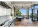 Spacious outdoor kitchen with large stainless grill, granite counters, and an amazing water view at 9724 Chestnut Ridge Dr, Windermere, FL 34786