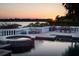 Sunset view from the pool area, featuring elegant railings, lush greenery, and tranquil water at 9724 Chestnut Ridge Dr, Windermere, FL 34786