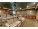 Home theatre features plush seating and custom bar with glassware at 9724 Chestnut Ridge Dr, Windermere, FL 34786