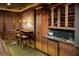 Charming wet bar area with custom wood cabinetry and an intimate seating arrangement at 9724 Chestnut Ridge Dr, Windermere, FL 34786