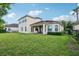 Spacious backyard featuring a well-manicured lawn and a luxurious villa at 9736 Hatton Cir, Orlando, FL 32832