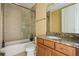 Bathroom featuring tiled shower/tub, granite vanity, and neutral color scheme at 9736 Hatton Cir, Orlando, FL 32832