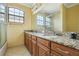 Bathroom featuring a granite countertop and dual sinks at 9736 Hatton Cir, Orlando, FL 32832