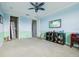 A playroom with a blue and green color scheme, ceiling fan, and space for playing and sleeping at 9736 Hatton Cir, Orlando, FL 32832