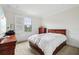 Bright bedroom with a large window, neutral paint, and wood furniture at 9736 Hatton Cir, Orlando, FL 32832