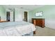 A spacious bedroom with an wrought iron bed frame, a television and neutral-toned carpet at 9736 Hatton Cir, Orlando, FL 32832
