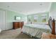Spacious bedroom with carpet, green walls, decorative trim, and natural light from the windows at 9736 Hatton Cir, Orlando, FL 32832