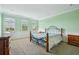 Bedroom featuring carpet, stylish decor, and ample natural light through the large windows at 9736 Hatton Cir, Orlando, FL 32832