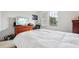 Bright bedroom with a large window, neutral paint, and television at 9736 Hatton Cir, Orlando, FL 32832