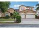 Charming two-story home featuring a stone facade, red tile roof, and lush tropical landscaping at 9736 Hatton Cir, Orlando, FL 32832