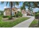 Beautiful two-story home with stone facade, red tile roof, tropical landscaping, and a two-car garage at 9736 Hatton Cir, Orlando, FL 32832