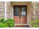 Close-up of a double front door with decorative glass inserts and a stone surround at 9736 Hatton Cir, Orlando, FL 32832