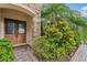 Inviting front entry with a double door, stone accents, and lush landscaping at 9736 Hatton Cir, Orlando, FL 32832