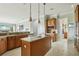 Open kitchen with wood cabinets, granite countertops, center island, and eat-in breakfast area at 9736 Hatton Cir, Orlando, FL 32832