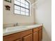 Laundry room featuring utility sink, countertop, and cabinets under a large window at 9736 Hatton Cir, Orlando, FL 32832