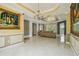 Open-concept living area showcasing tiled floors, decorative paintings and neutral color palette at 9736 Hatton Cir, Orlando, FL 32832