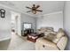 Spacious living room featuring neutral paint and carpet, leather sofas, and a ceiling fan at 9736 Hatton Cir, Orlando, FL 32832